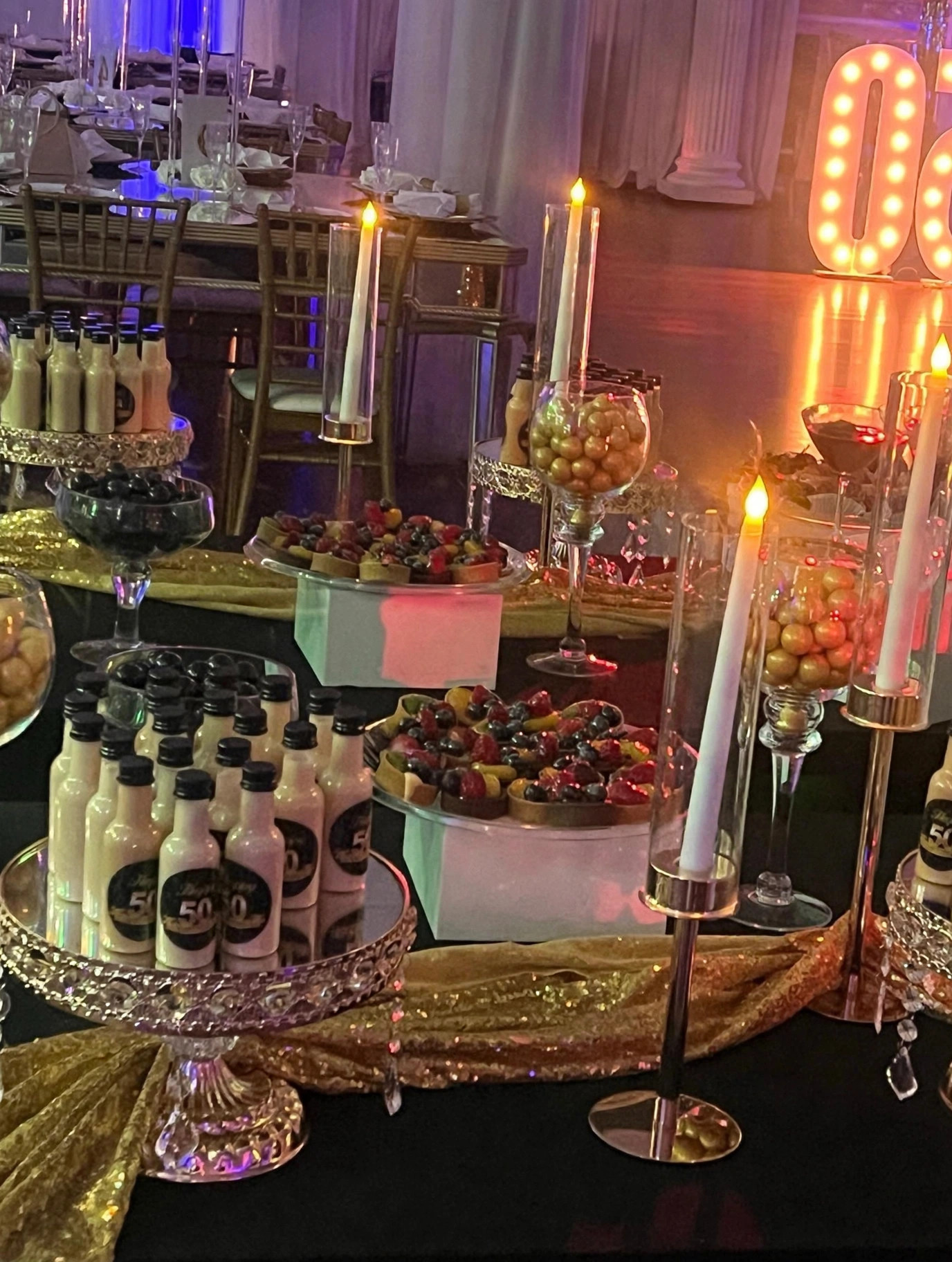 Dessert table with candles and treats for a 50th birthday