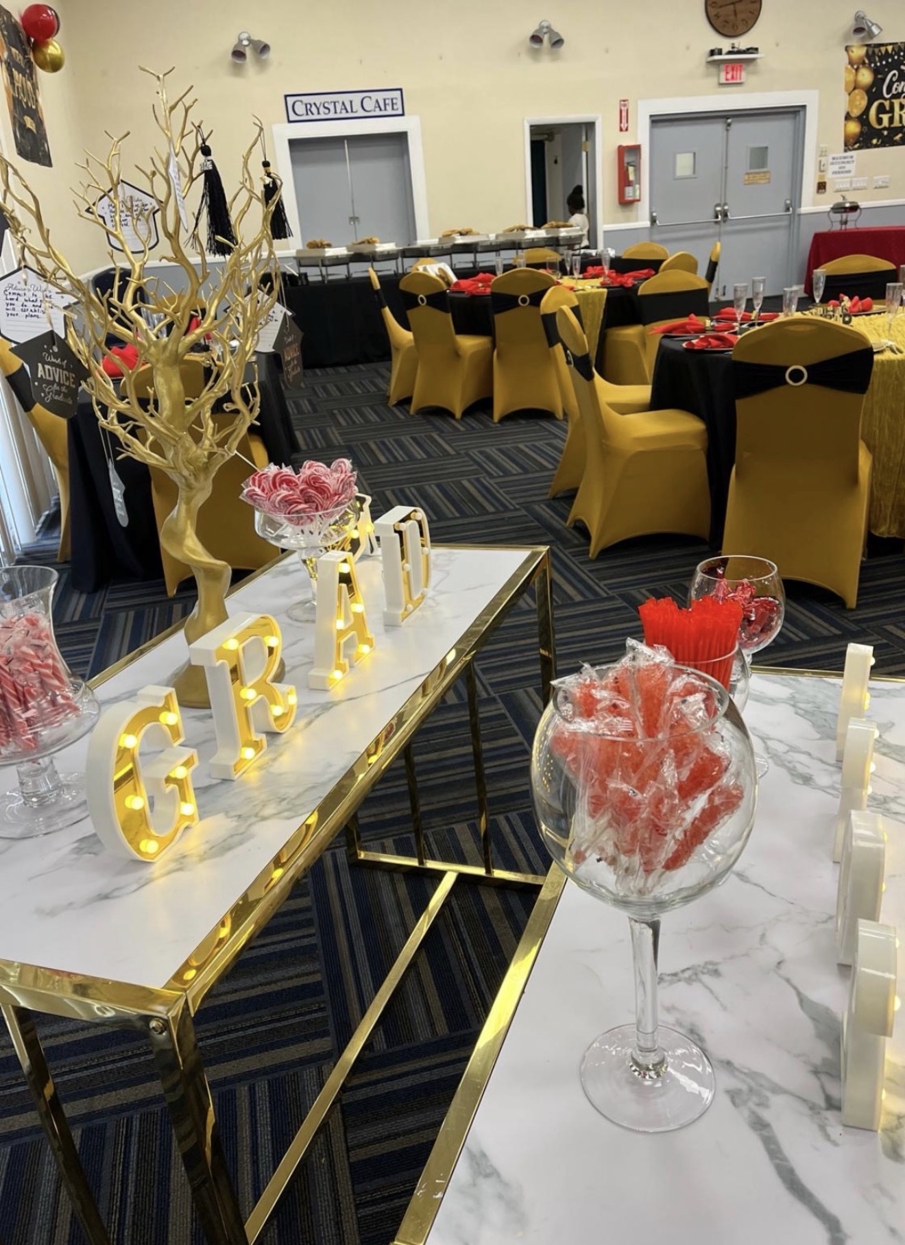Graduation dessert table decorated in red, black and gold