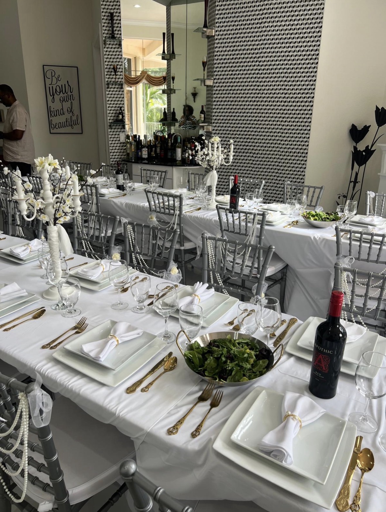 Elegant Perfect Hands event setup with white linens, chiavari chairs, and gold flatware